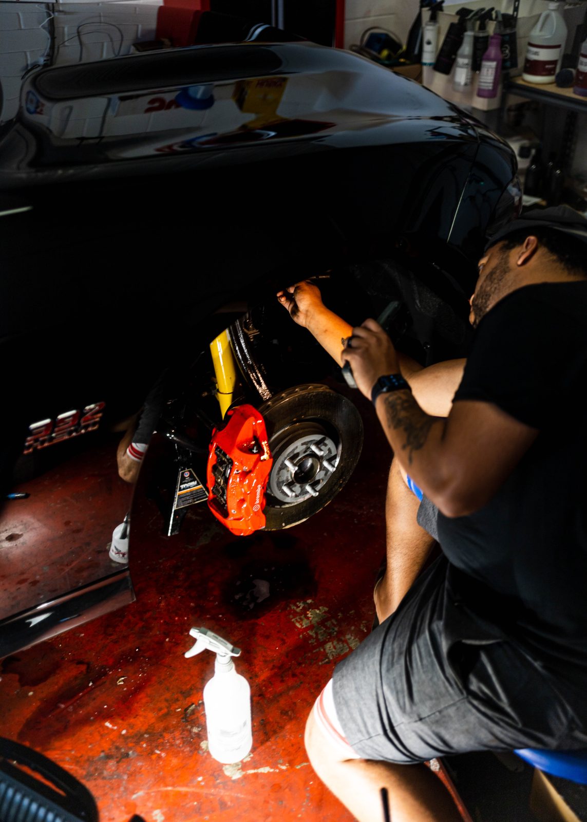Obsidian detailer servicing an engine bay during a maintenance visit in Baltimore
