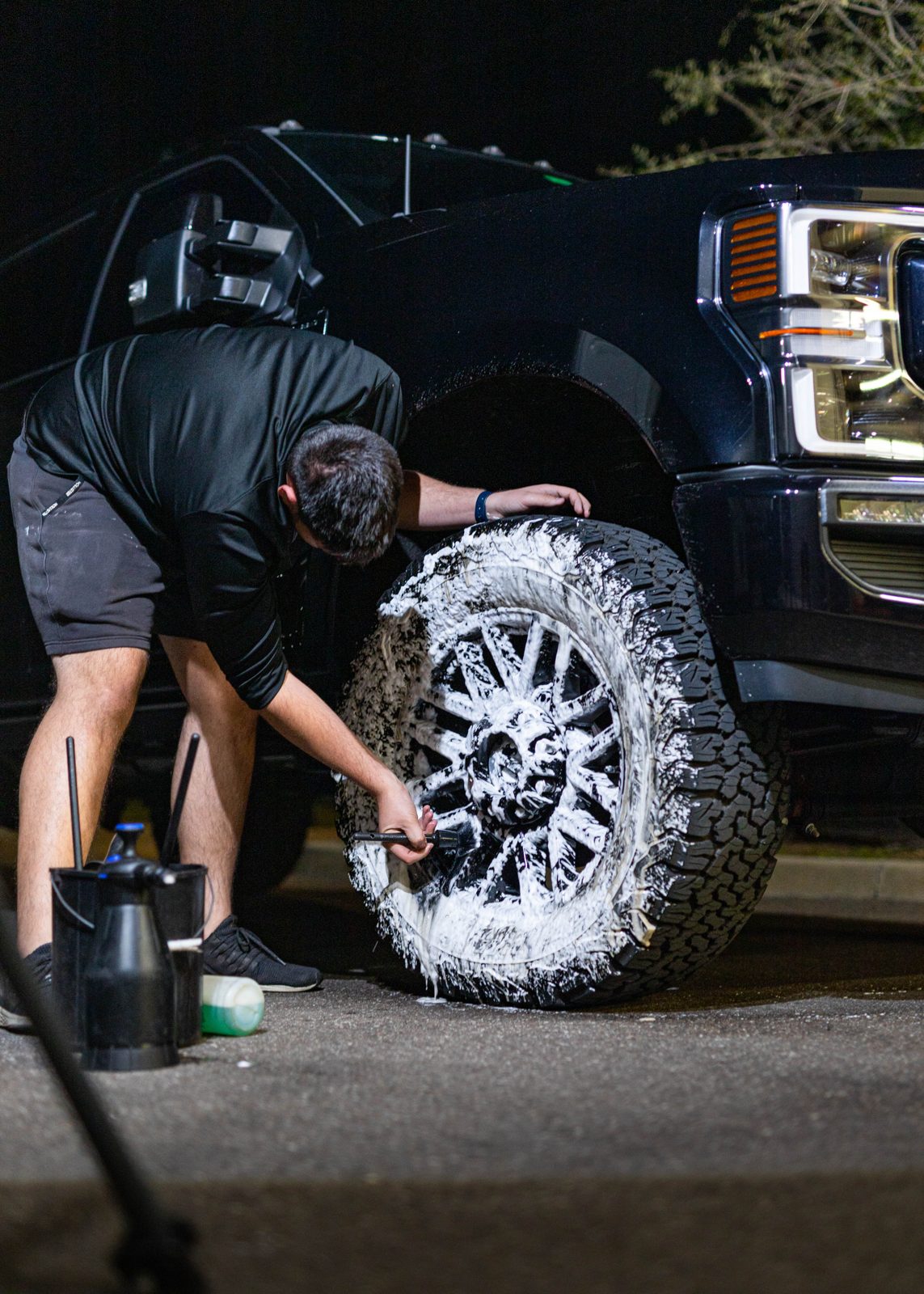Obsidian detailer polishing a truck wheel on a recurring detailing plan in Towson